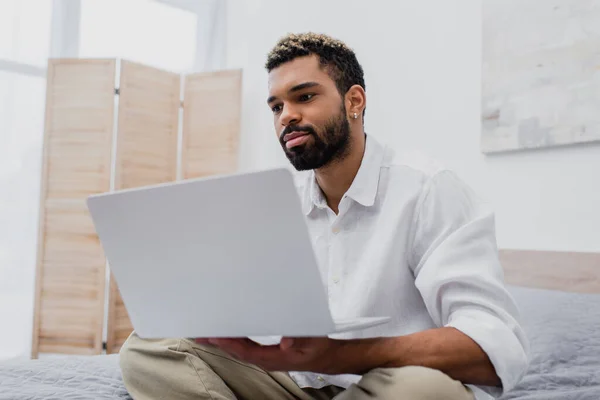 Young African American Man Holding Laptop Hands While Sitting Bed — Stock Photo, Image