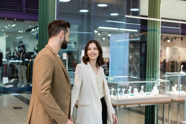 Smiling Woman Looking Boyfriend While Walking Jewelry Shop — Stock Fotó