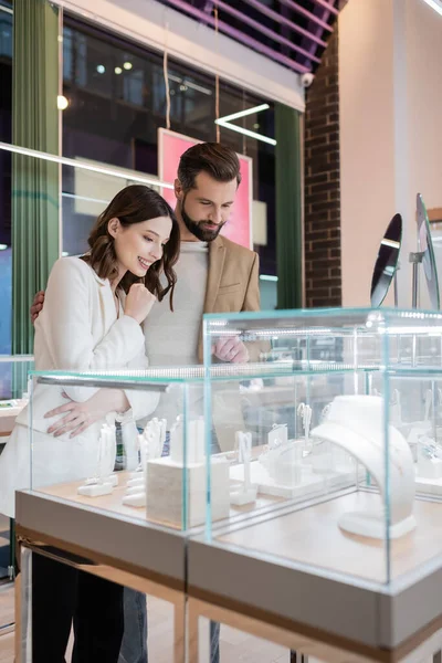 Excited Woman Looking Jewelry Boyfriend Store — Stock fotografie