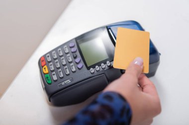 Cropped view of woman paying with credit card in shop  clipart