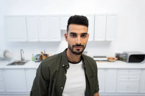 Young Muslim Man Looking Camera Blurred Kitchen — Stok fotoğraf