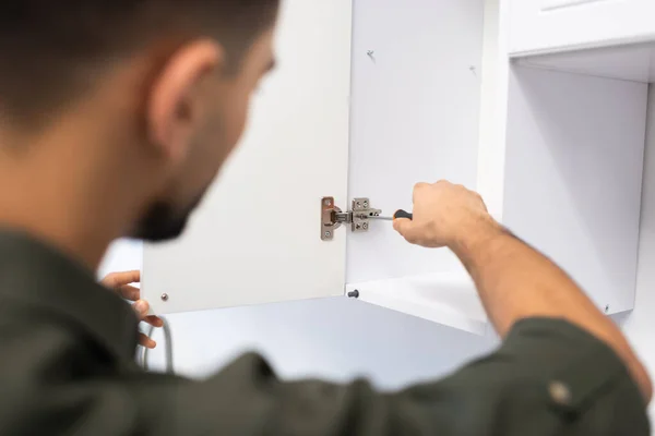 Blurred Man Fixing Kitchen Cabinet Home — Stockfoto