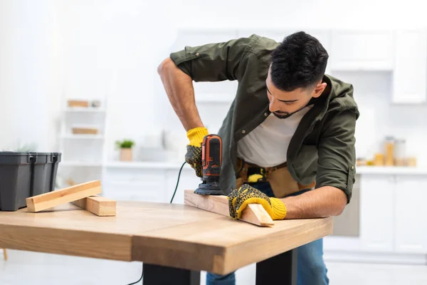 Young Muslim Man Gloves Sanding Wooden Plank Sander Home — Fotografia de Stock