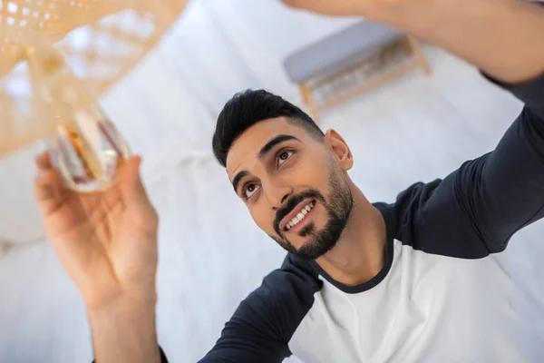 High Angle View Cheerful Muslim Man Changing Lightbulb Blurred Chandelier — Stock Photo, Image