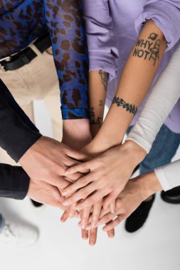 cropped view of lgbtq community people joining hands together on white background clipart