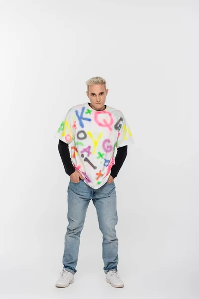 Young Gay Man Alphabet Print Shirt Standing Hands Pockets Jeans — 스톡 사진