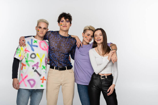 young lgbtq community friends looking at camera while embracing isolated on grey