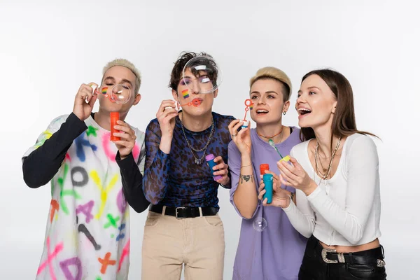 Joyful Lgbtq Community Friends Having Fun Blowing Soap Bubbles Isolated — стоковое фото