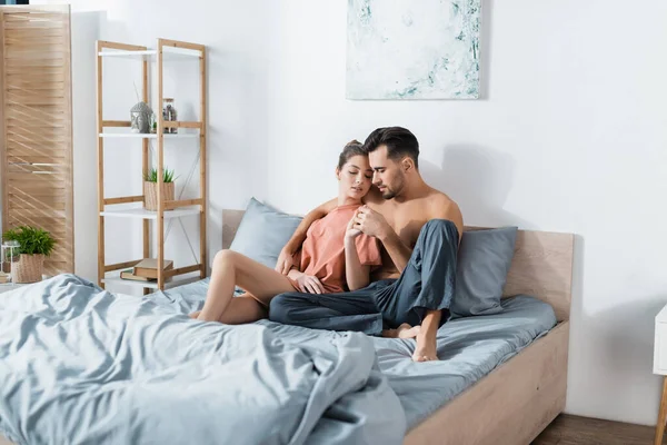 Sexy Woman Shirt Holding Hands Man Pajama Pants While Sitting — Stock Photo, Image