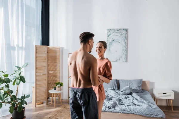 Cheerful Woman Shirt Laughing Shirtless Boyfriend Embracing Her Bedroom — Stock Photo, Image
