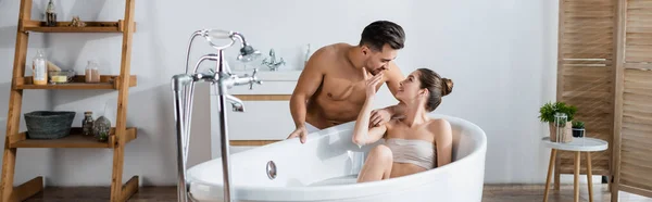 Seductive Woman Relaxing Bathtub Touching Face Sexy Muscular Boyfriend Banner — Stock Photo, Image