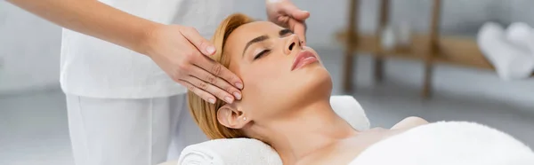 Masseur doing head massage of blonde client with closed eyes, banner — Stock Photo