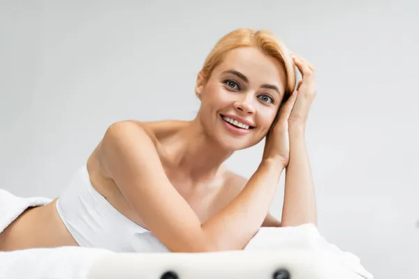 Glücklich blond client liegend auf massagetisch — Stockfoto