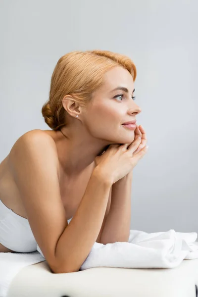 Pleased blonde client lying on massage table — Stock Photo