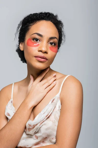 Pretty african american woman in eye patches looking at camera isolated on grey — Stock Photo