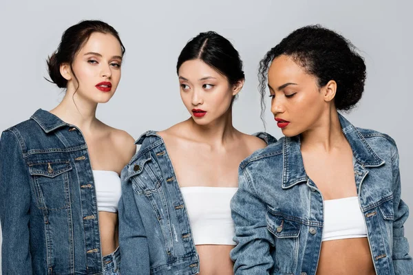 Pretty multicultural women with red lips posing isolated on grey — Stock Photo