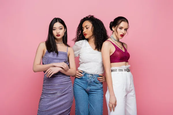 Stylish multiethnic women posing isolated on pink — Stock Photo