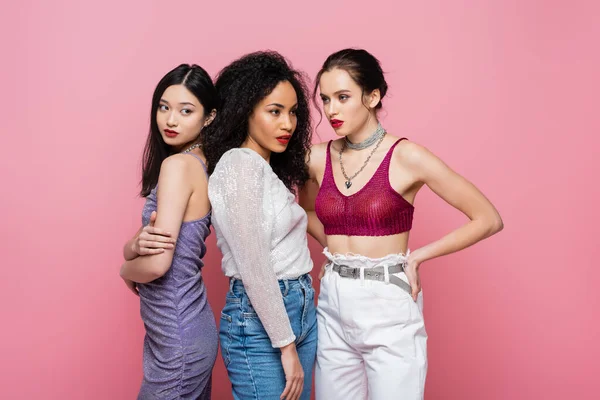 Pretty young interracial women posing isolated on pink — Stock Photo