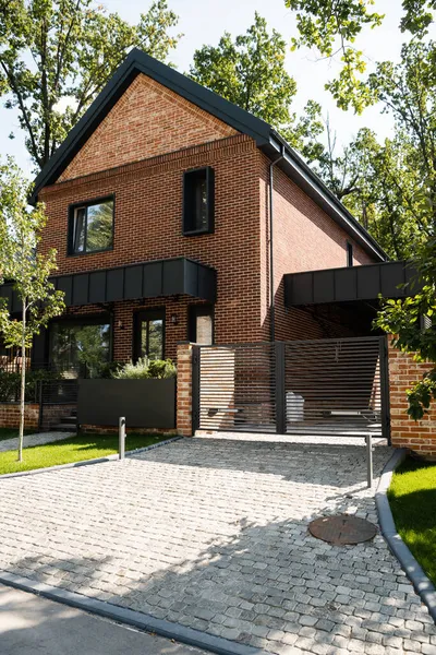 Sunshine on modern house near green trees — Stock Photo