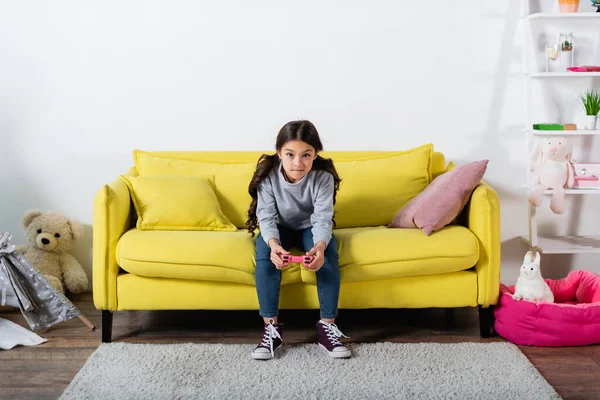 KYIV, UKRAINE - SEPTEMBER 17, 2021: tensed preteen kid playing video game at home — Stock Photo