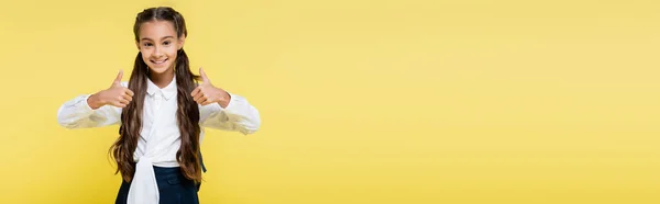 Happy preteen pupil showing thumbs up isolated on yellow, banner — Stock Photo