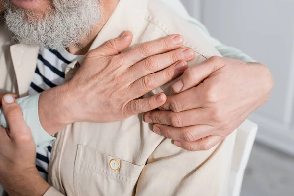 Cropped view of woman hugging mature husband at home — Stock Photo