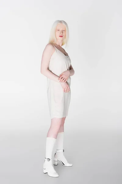 Full length of trendy albino model in dress and hells on white background — Stock Photo