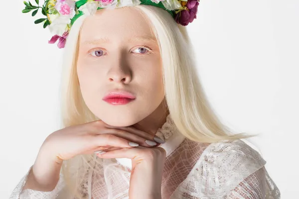 Portrait of pretty albino woman in wreath with flowers looking at camera isolated on white — Stock Photo