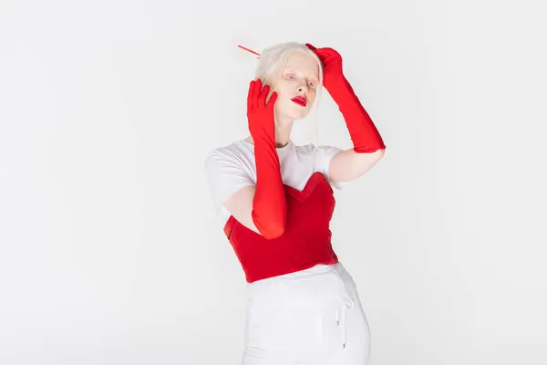 Trendy albino model with red lips posing isolated on white — Stock Photo