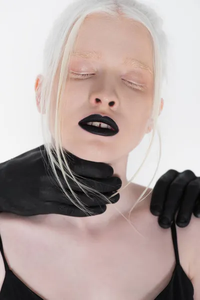 Mani maschili in vernice nera toccando donna albina isolata su bianco — Foto stock
