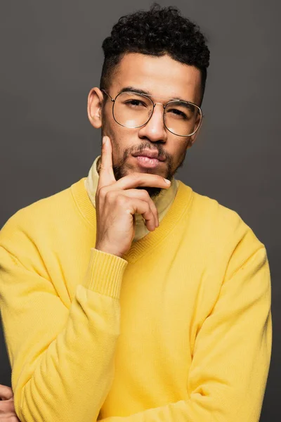 Serious african american man in glasses looking at camera isolated on grey — Stock Photo