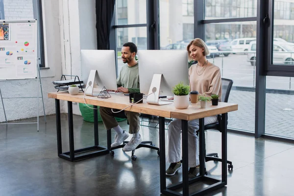 Allegri colleghi interrazziali che lavorano in ufficio moderno — Foto stock