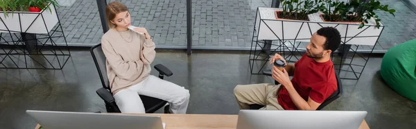 High angle view of interracial colleagues looking at each other in modern office, banner — Stock Photo