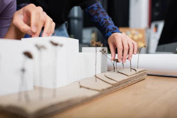 Cropped view of architects near house model on desk — Stock Photo