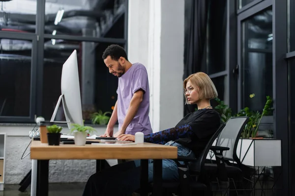 Focused multiethnic colleagues working on start up in modern office — Stock Photo