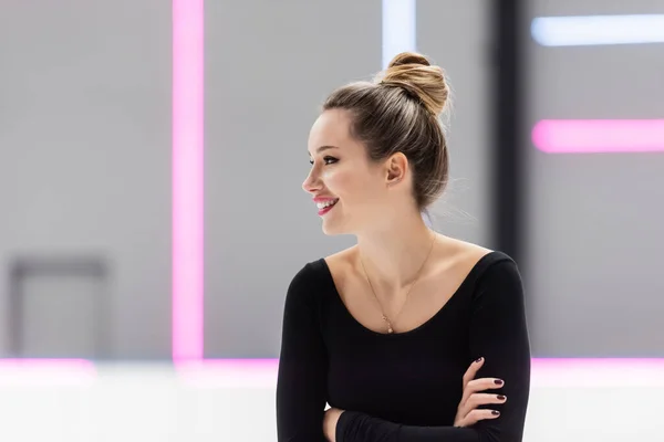 Happy figure skater posing with crossed arms — Stock Photo