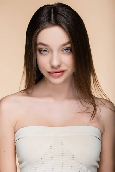 Pretty young woman with bare shoulders isolated on beige — Stock Photo