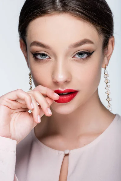 Flirty giovane donna in orecchini toccare labbra isolato su grigio — Foto stock