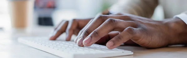 Close up view of african american man typing on computer keyboard, banner — Stock Photo