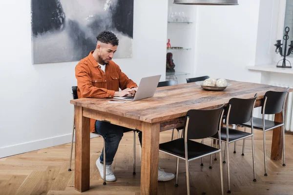 African american freelancer typing on laptop while working from home — Stock Photo