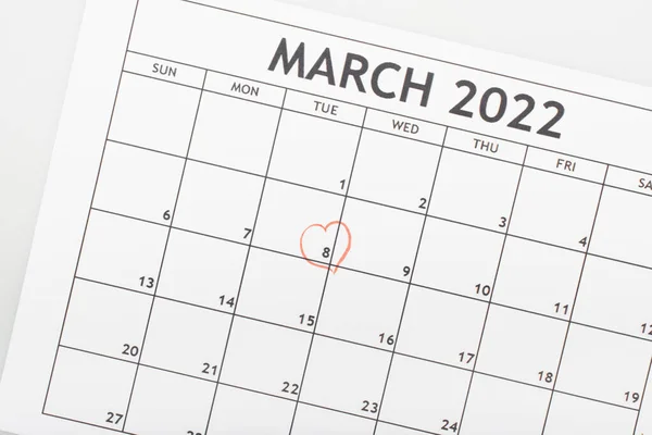Top view of march 2022 calendar with drawn heart around 8 march date isolated on white — Stock Photo