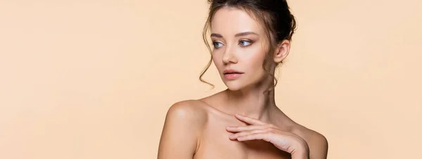 Young brunette woman touching chest isolated on beige, banner — Stock Photo