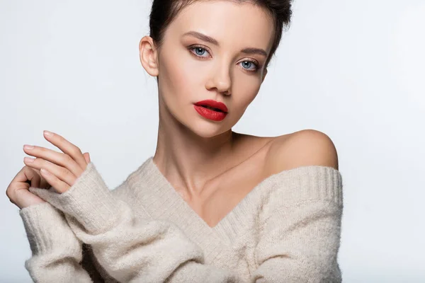 Stylish woman with red lips in warm sweater looking at camera isolated on white — Stock Photo