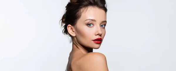 Young woman with red lips and naked shoulder looking at camera isolated on white, banner — Stock Photo