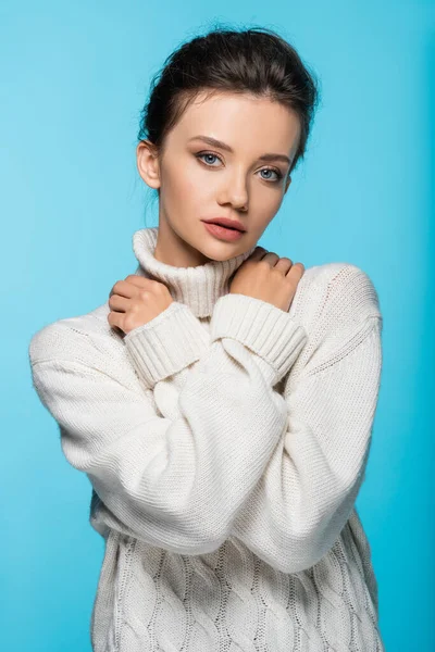 Woman in white sweater posing isolated on blue — Stock Photo