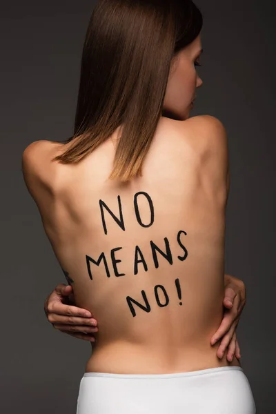 Brunette woman with no means no inscription on back isolated on dark grey — Stock Photo