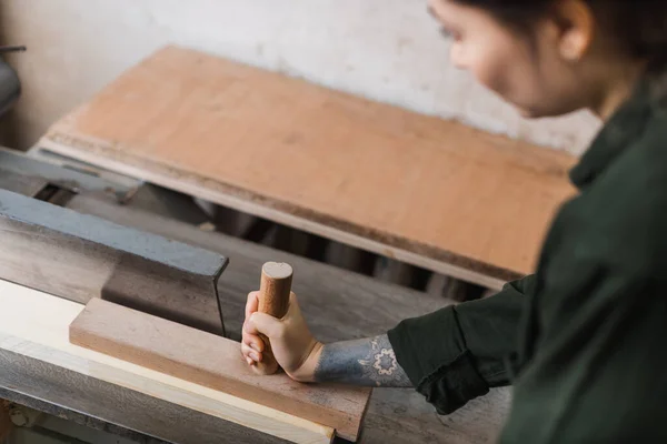 Blurred craftswoman working with jointer machine in workshop — Stock Photo