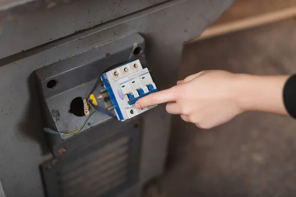 Cropped view of furniture designer turning on jointer machine — Stock Photo