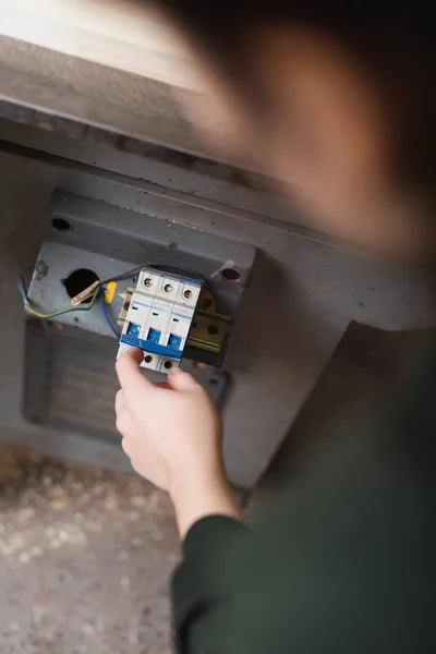 Top view of blurred carpenter turning on jointer machine — Stock Photo