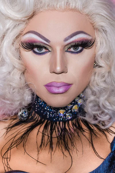 Close up portrait of drag queen with spectacular makeup, in wig and glitter necklace — Stock Photo